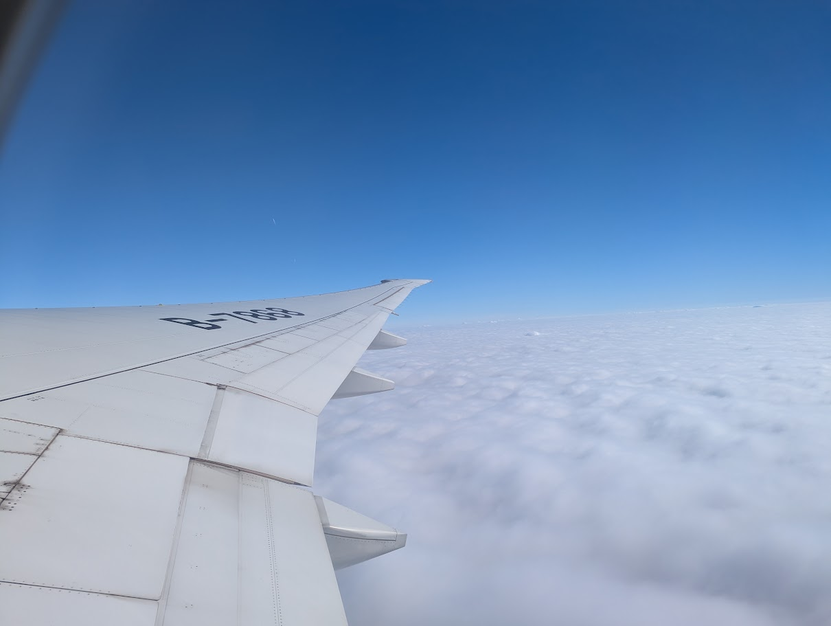 An plane wing is visible in the picture. The plane sign "B-7868" is visible on the wing.
